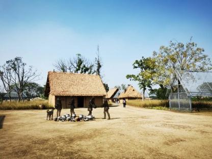 metal grid figures and reconstructed houses inside of the Liangzhu Ancient City Ruins Park