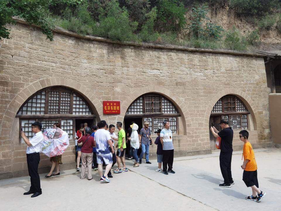 Chinese tourists coming out of Mao Zedong's former Yaodong cave house at the Yangjialing Revolutionary Site