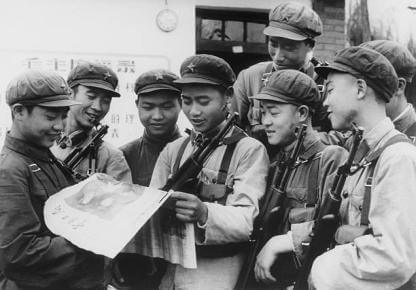 Chinese Red Guards reading a propaganda newspaper