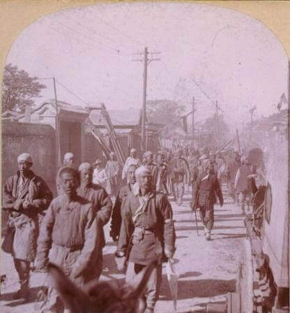 Group of Boxers walking down the street in Tien-Tsin (now called Tianjing)