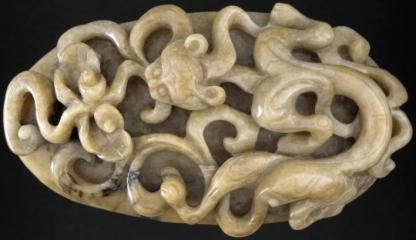 oval buckle plaque with dragon and ruyi scrolls made out of jade or soapstone during the Yuan dynasty